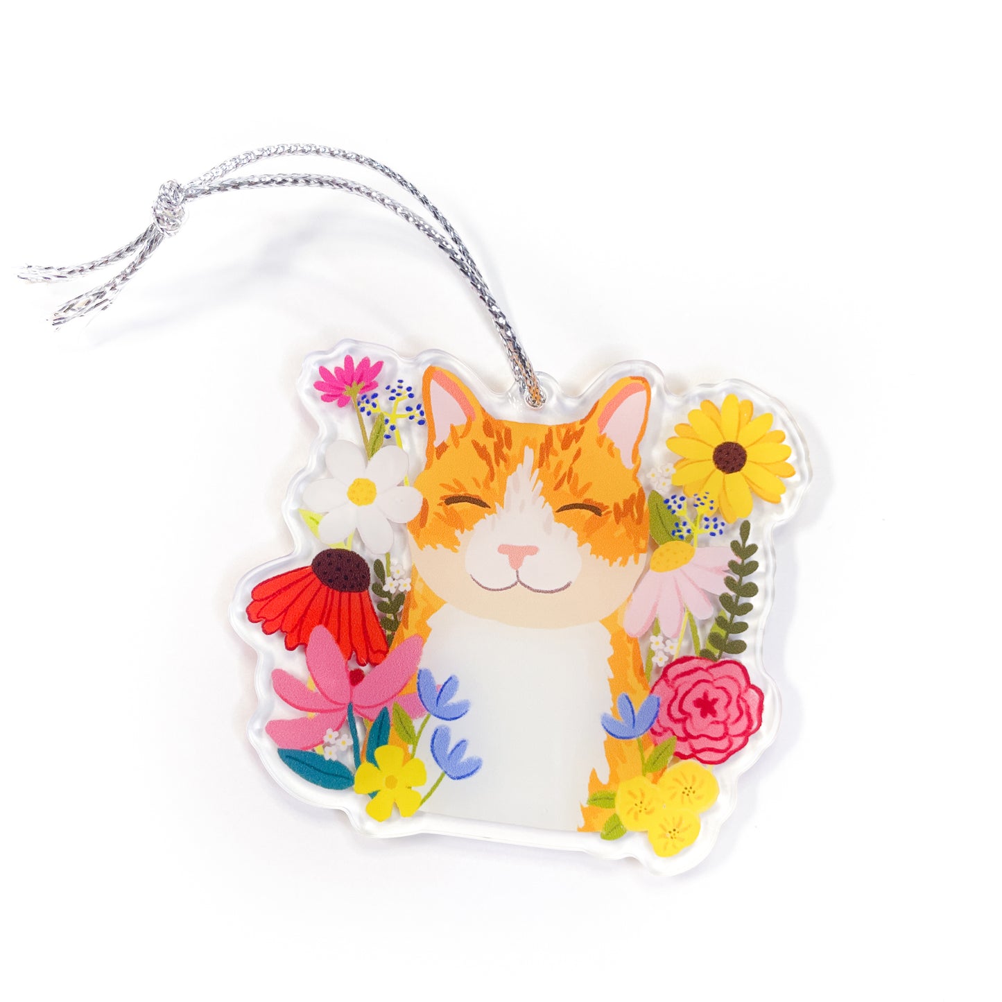 Happy orange tabby cat with wildflowers acrylic ornament with silver string showing smiling cat surrounded by colorful flowers on white background