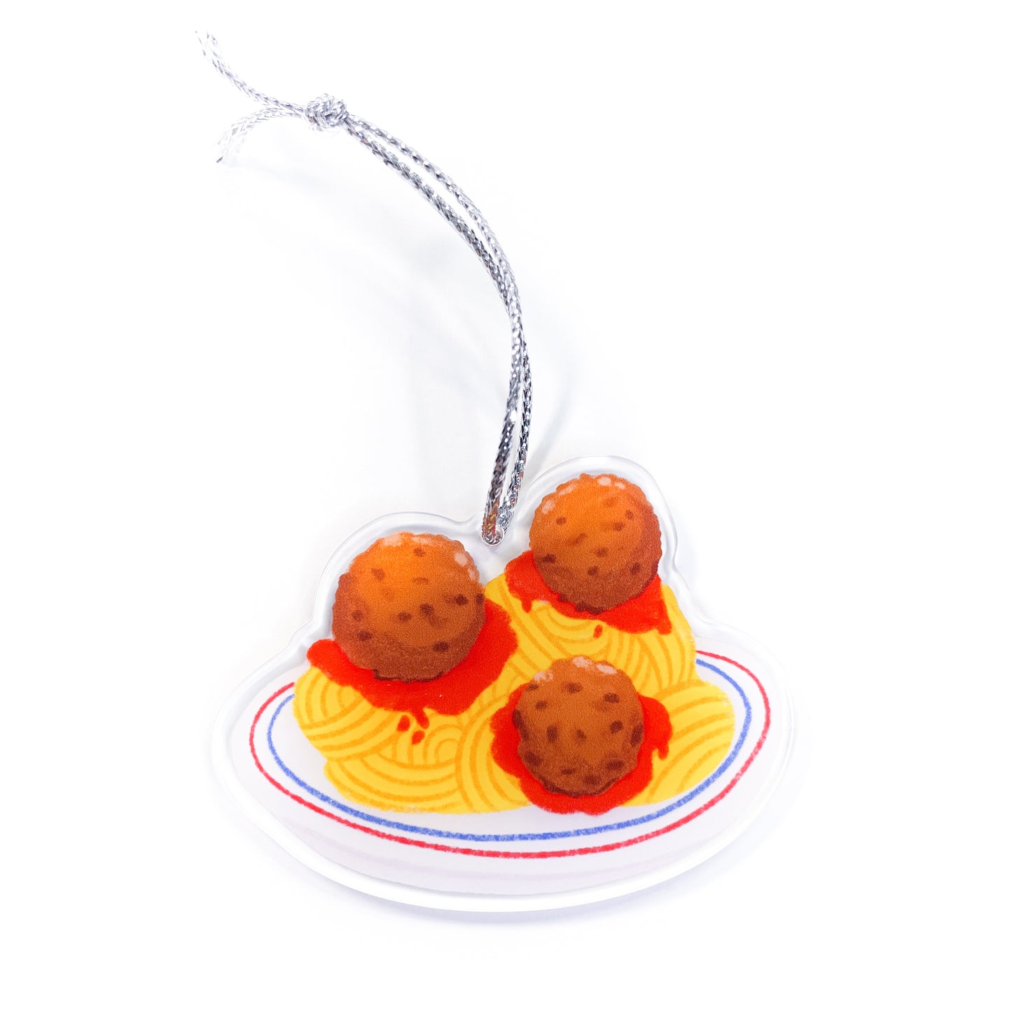 Spaghetti and meatballs acrylic ornament with silver string showing pasta with red sauce and three meatballs on white plate on white background