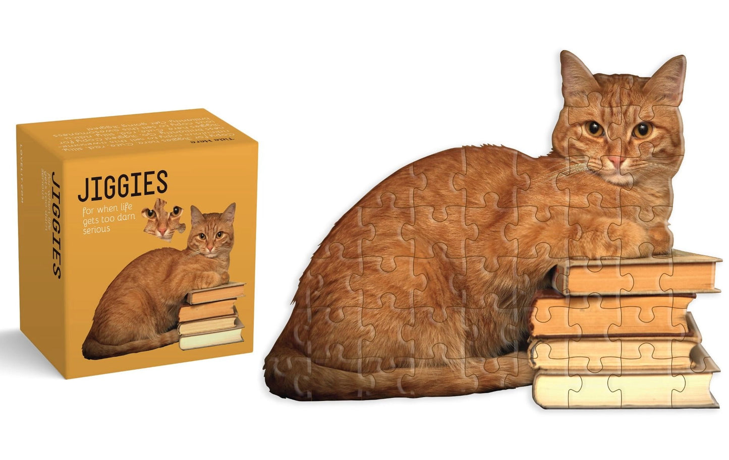 mini puzzle of an orange  cat laying on a stack of books with packaging box next to it
