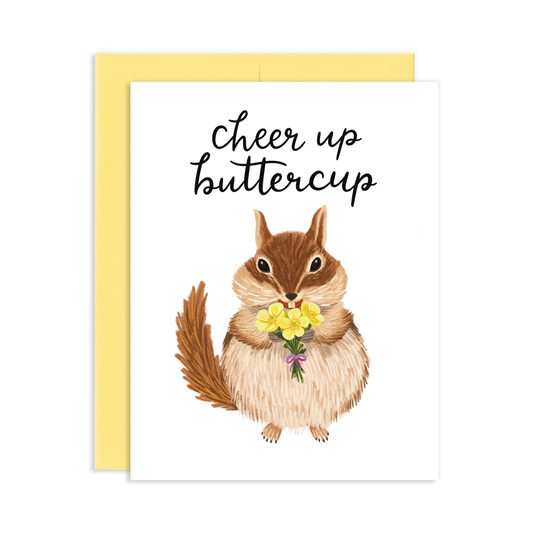 Greeting card with an illustration of a cute chipmunk holding a bouquet of yellow buttercup flowers and a yellow envelope. Reads 'Cheer Up Buttercup' in cursive letters.