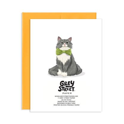 Card back view with a smiling cat illustration with green bowtie and 'Grey Street Paper' branding on a white background
