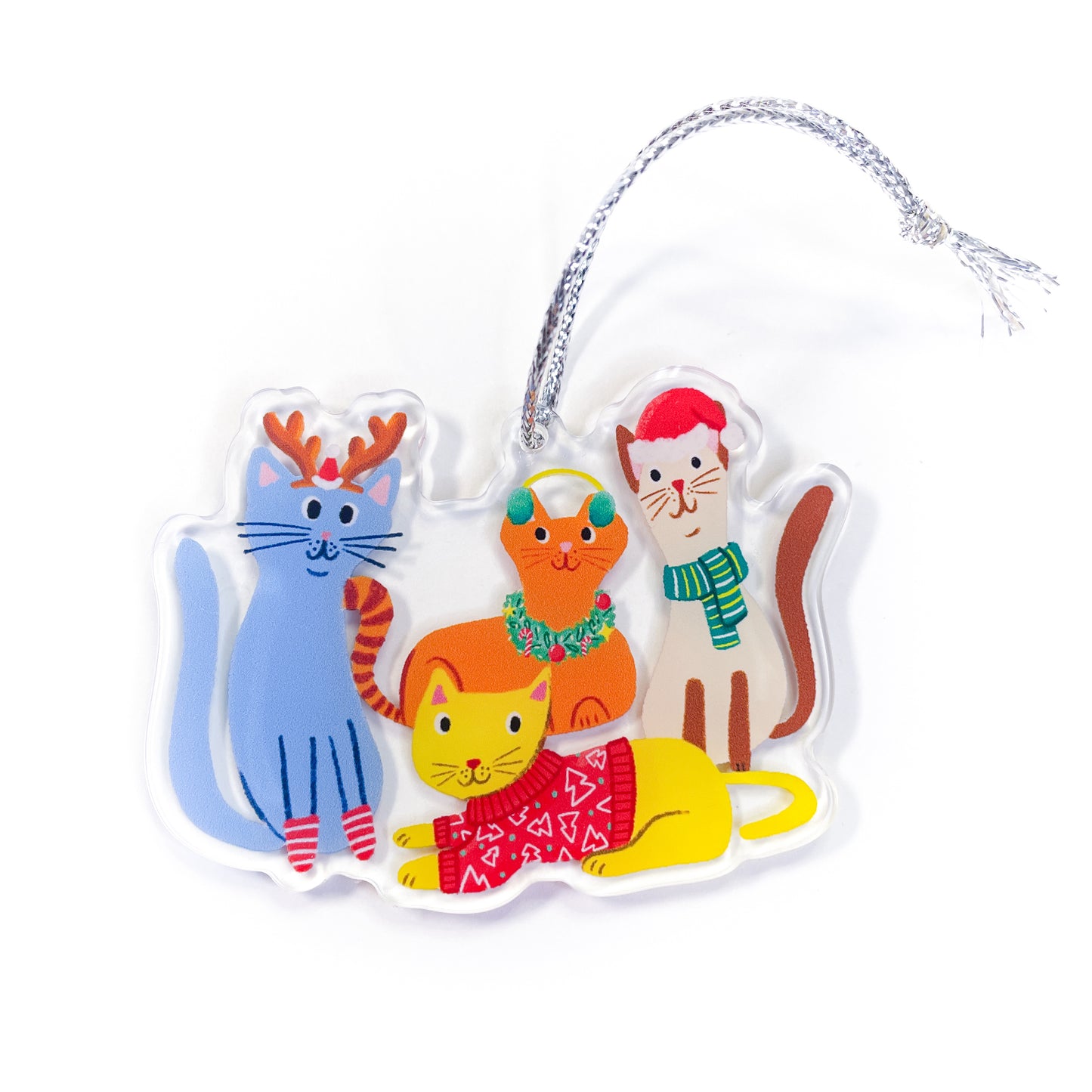 Holiday cats acrylic ornament featuring five cute cats in Christmas outfits: periwinkle blue cat with brown reindeer antlers and red and white striped socks, orange tabby cat wearing green wreath with red berries, cream and brown Siamese cat in red Santa hat with green and blue striped scarf, bright yellow cat wearing red sweater with white triangle pattern, and partial orange cat with yellow ear muffs on clear acrylic with silver hanging string