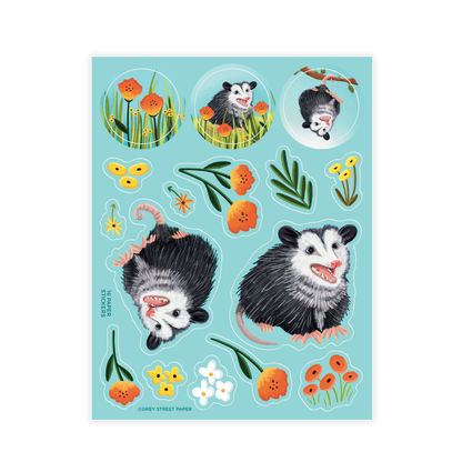 A collection of paper stickers featuring cartoon-style opossums and various flowers, designed for use as decoration on notebooks, planners, scrapbooks, and envelopes.