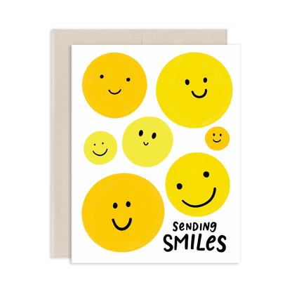 Greeting card with yellow smile faces and 'Sending Smiles' text on a white background
