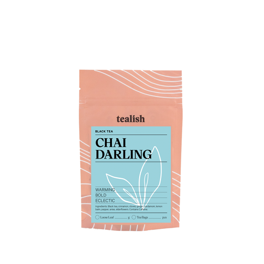 A package of Tealish Chai Darling Black Tea with a pink bag and blue label design.