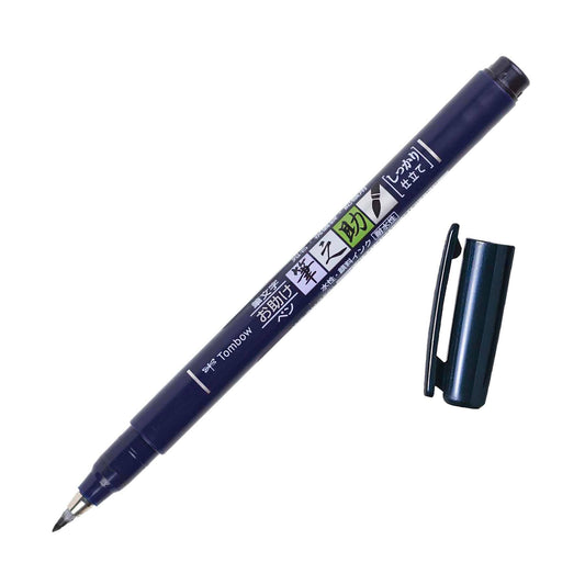 A black Tombow Fudenosuke brush pen with a flexible brush tip and water-based pigment ink, displayed next to its cap.